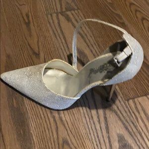 Silver high heel closed toe shoes.